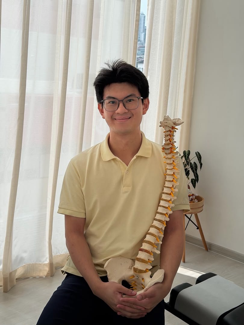 Portrait of chiropractor Siew Wai Han holding a spine model